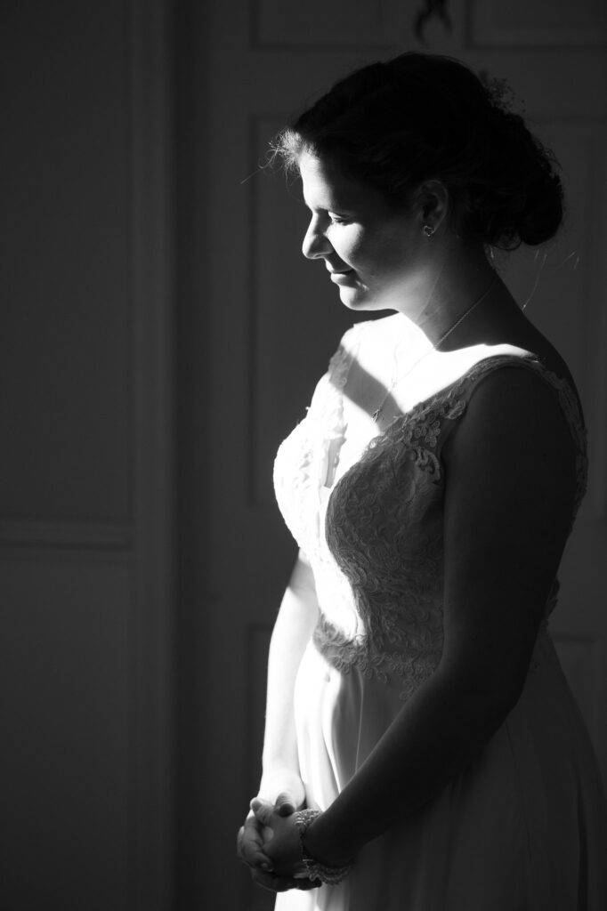 High-contrast black and white bridal portrait using window light at 108 W Main.