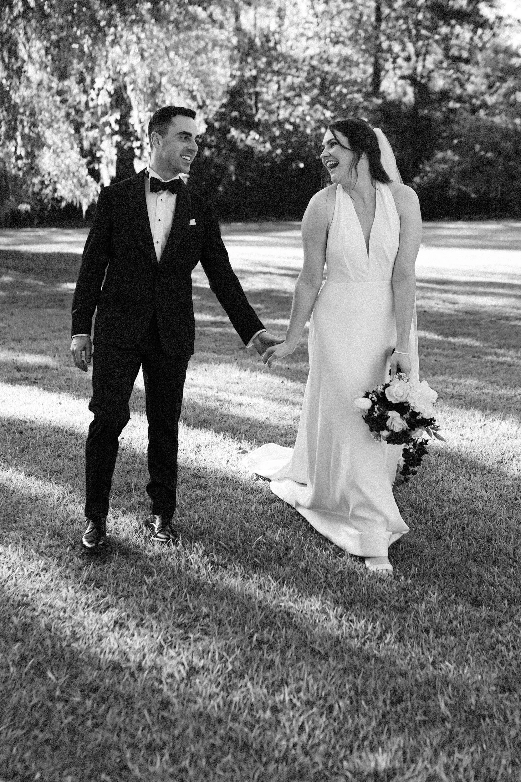 Bride and groom walking and laughing at Lovegrove Estate in Summerville, SC